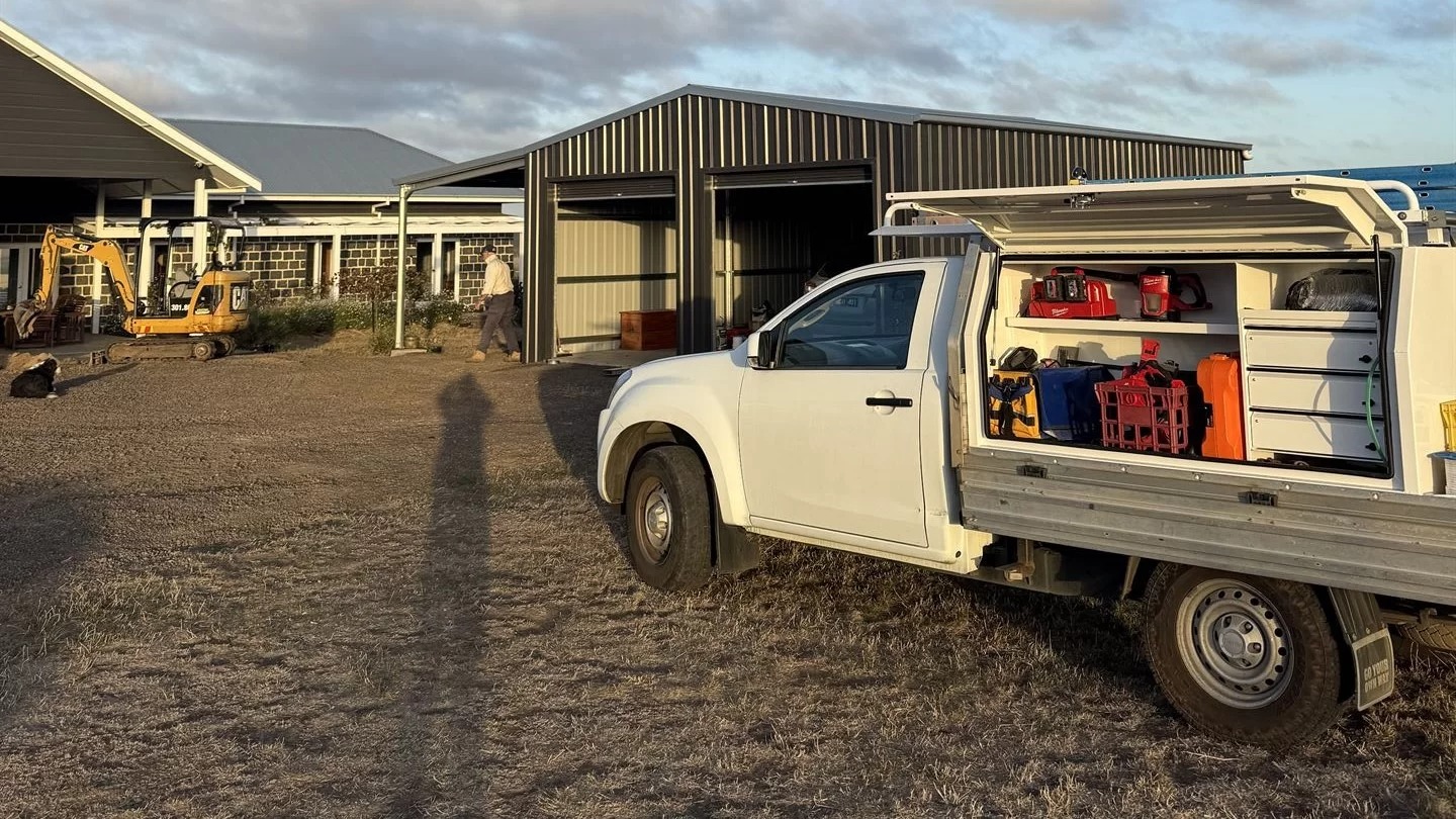 The JSM ute on a rural property with its canopy open and tools organised on the shelves